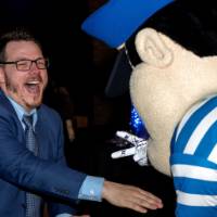 Grad laughs playing rock paper scissors with Louie